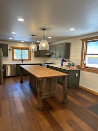 a kitchen with wood floors and a large island