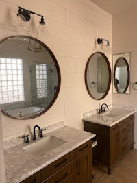 a bathroom with two sinks and a mirror
