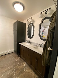 a bathroom with two sinks and a mirror