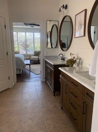 a bathroom with two sinks and a mirror