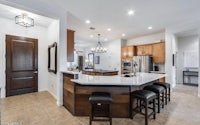 a kitchen with a center island and bar stools
