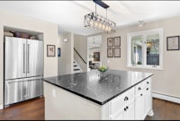 a kitchen with a marble counter top and stainless steel appliances