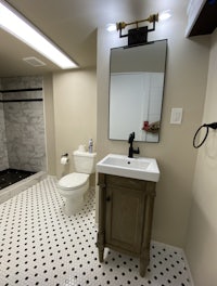 a bathroom with a black and white checkered floor