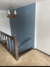a room with a blue wall and a staircase