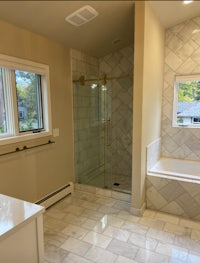 a bathroom with a tub, shower, and sink