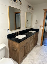 a bathroom with two sinks and a mirror