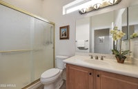 a bathroom with a glass shower stall