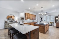 a kitchen with wooden cabinets and counter tops