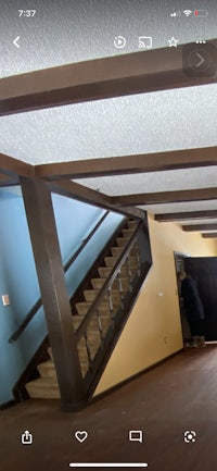 a person is walking down a staircase in a house