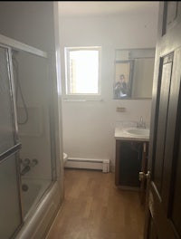 a bathroom with a toilet, shower, and sink