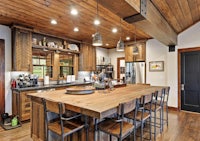 a rustic kitchen with wooden cabinets and a large island
