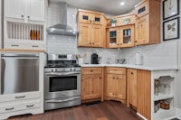 a kitchen with wooden cabinets and stainless steel appliances