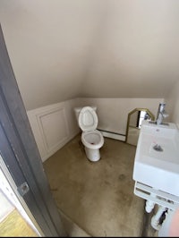 a bathroom with a toilet and sink in it