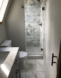 a bathroom with a shower, sink and toilet