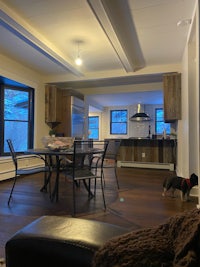 a living room with a dining table and chairs