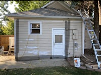 a house is being painted with a ladder