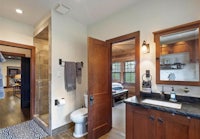 a bathroom with a sink, toilet and shower